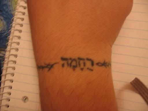 hebrew tattoo. hebrew tattoo on spine.